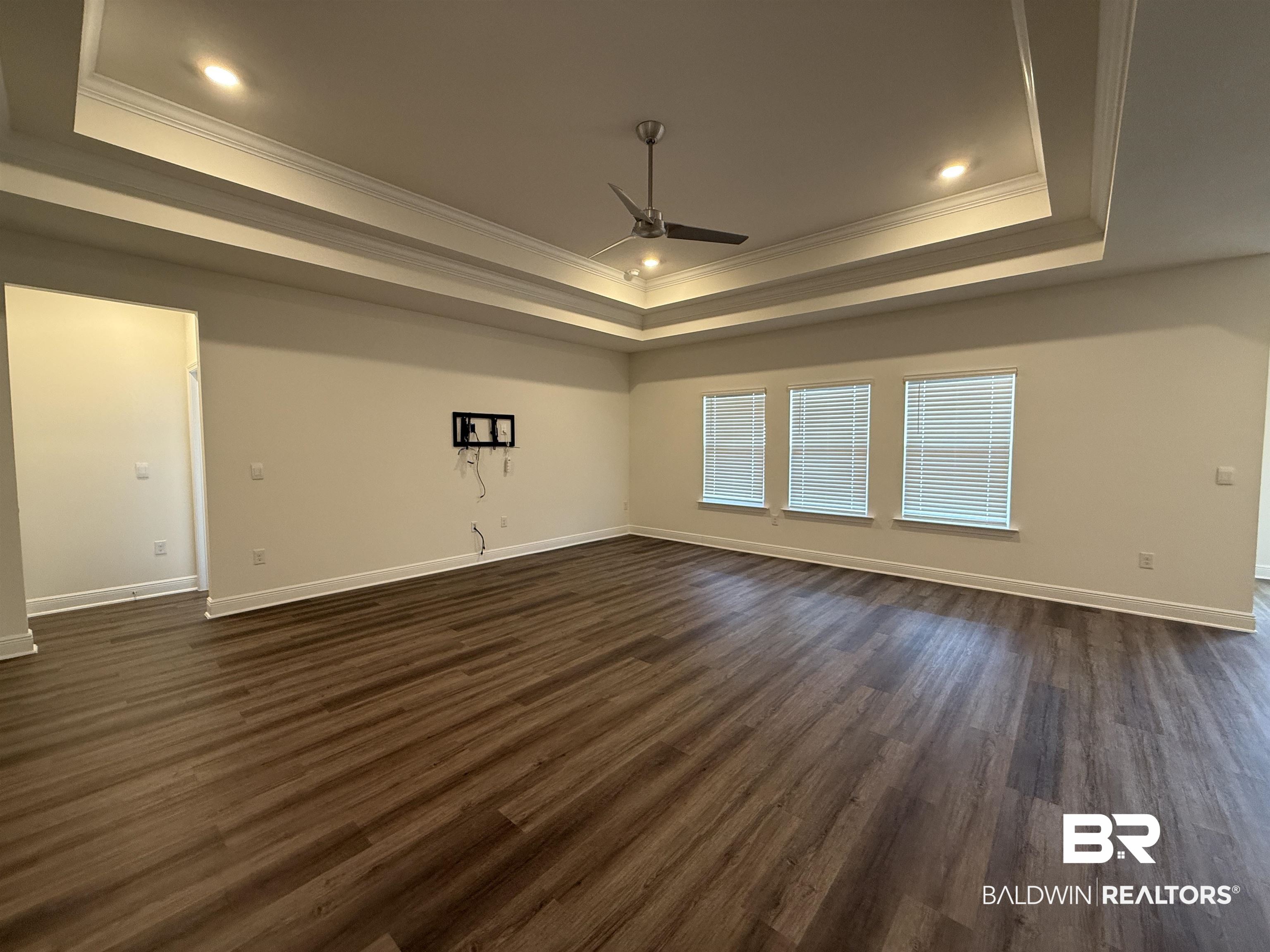 11442 Genuine Risk Circle Daphne, AL 36526 - Photo 3 of 21 Unfurnished room with dark wood-type flooring, ceiling fan, and ornamental molding