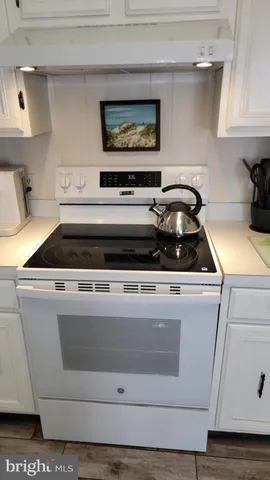 a stove top oven sitting inside of a kitchen