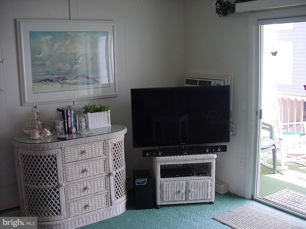11 91st Street, Unit 102 Ocean City, MD 21842 - Photo 12 of 43 a living room with furniture and a flat screen tv