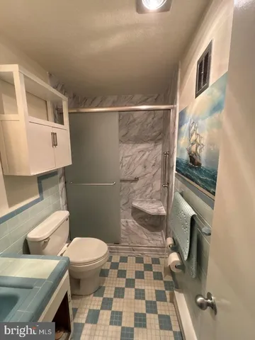 a bathroom with a toilet and a shower