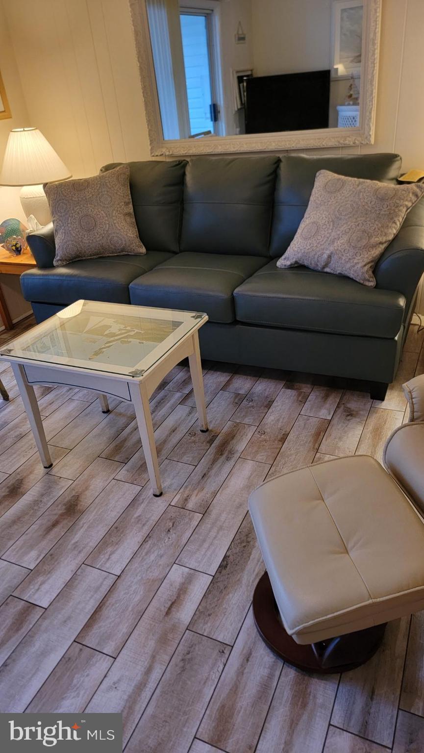 11 91st Street, Unit 102 Ocean City, MD 21842 - Photo 28 of 43 a living room with furniture and a couch
