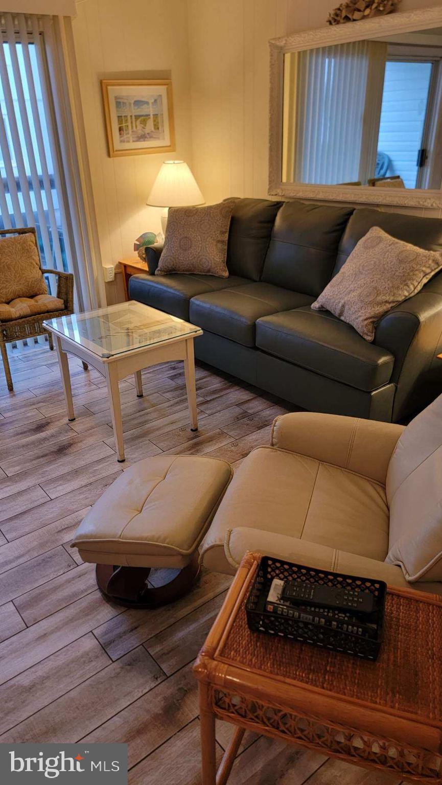 11 91st Street, Unit 102 Ocean City, MD 21842 - Photo 31 of 43 a living room with furniture and a rug