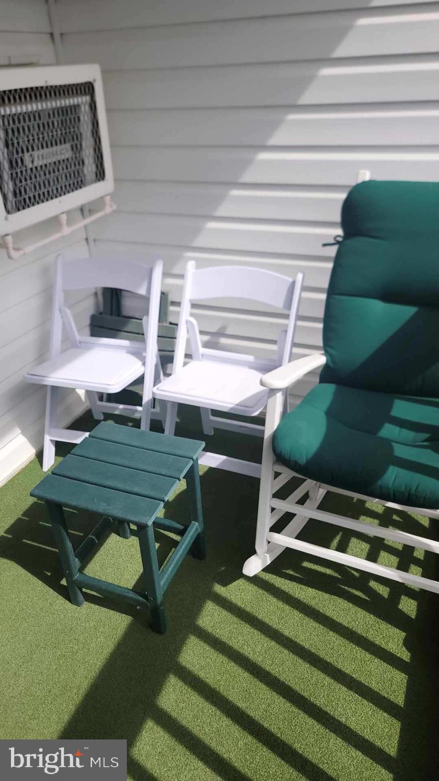 11 91st Street, Unit 102 Ocean City, MD 21842 - Photo 35 of 43 a view of a balcony with chairs and a stove