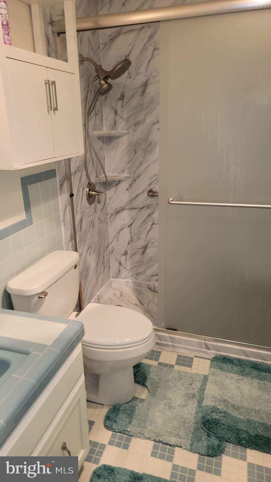 11 91st Street, Unit 102 Ocean City, MD 21842 - Photo 39 of 43 a white toilet sitting next to a shower