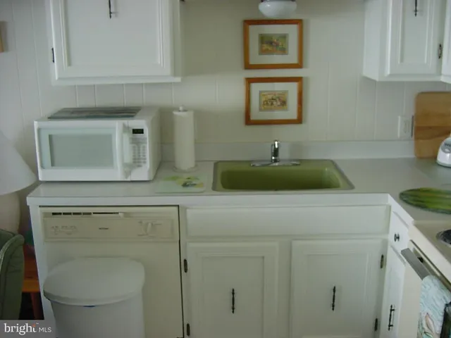 a view of a sink and cabinets