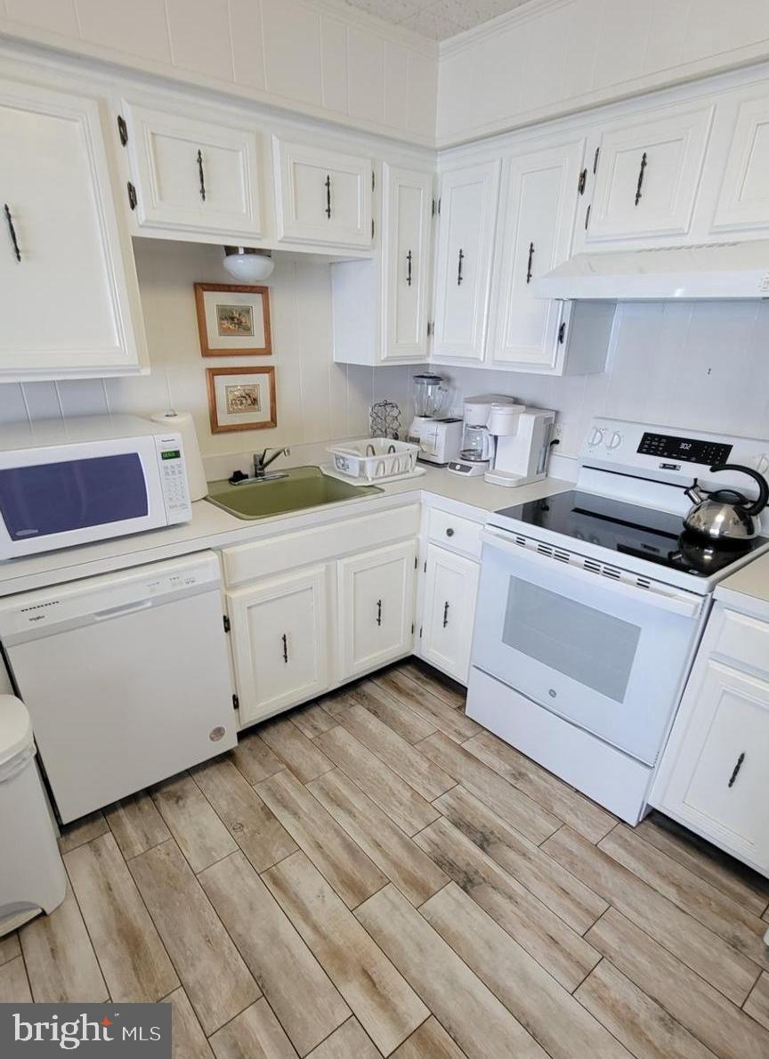 11 91st Street, Unit 102 Ocean City, MD 21842 - Photo 7 of 43 a kitchen with cabinets stainless steel appliances and a sink