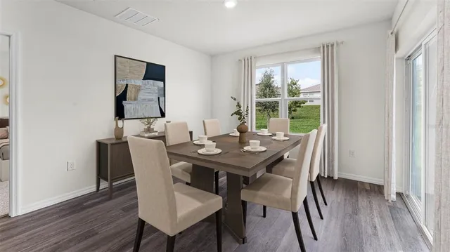 a view of a dining room with furniture window and wooden floor