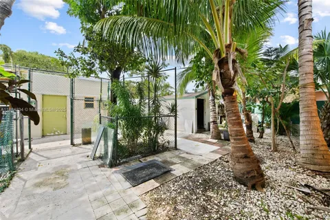 a backyard of a house with barbeque oven table and chairs