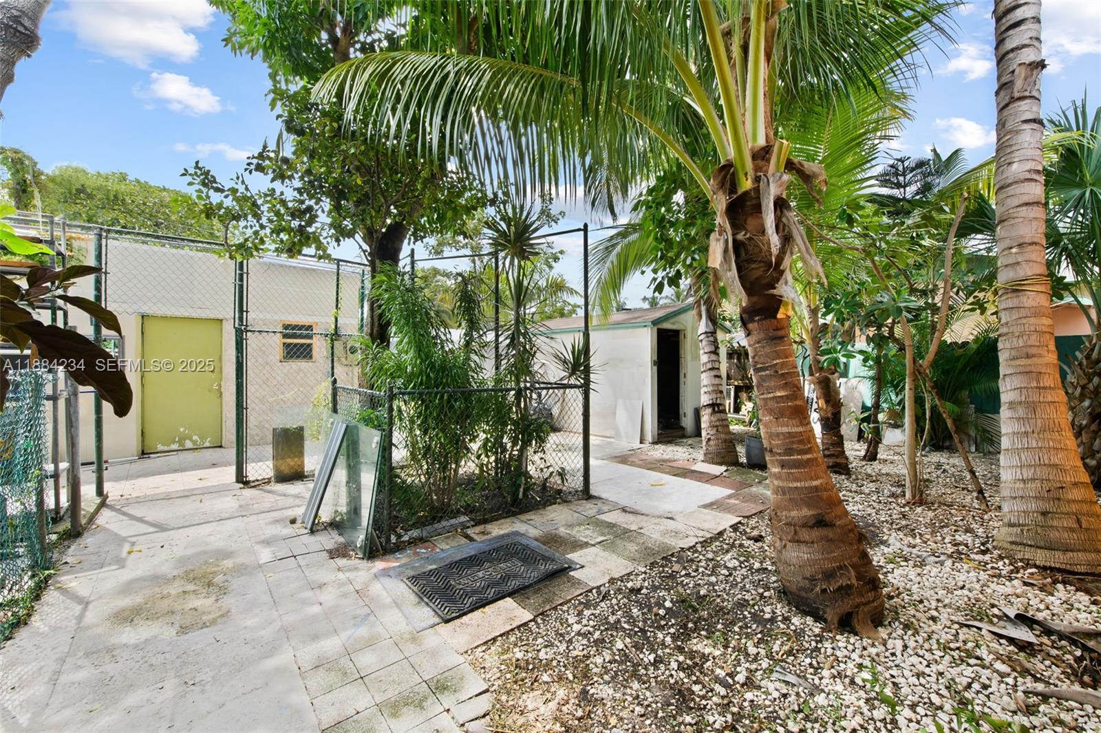 1932 Adams Street Hollywood, FL 33020 - Photo 11 of 11 a backyard of a house with barbeque oven table and chairs