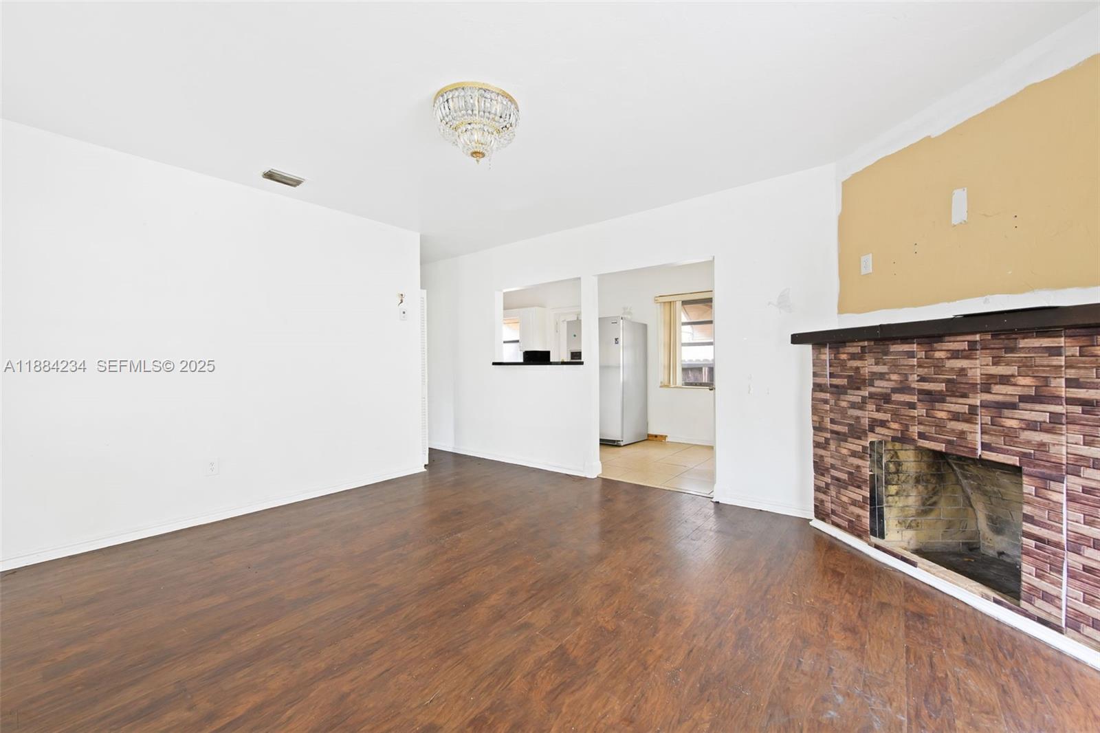 1932 Adams Street Hollywood, FL 33020 - Photo 3 of 11 a view of empty room with wooden floor and fireplace
