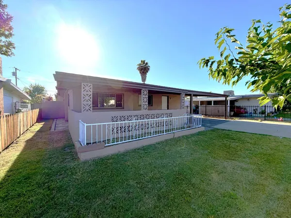 a view of a house with a yard and deck
