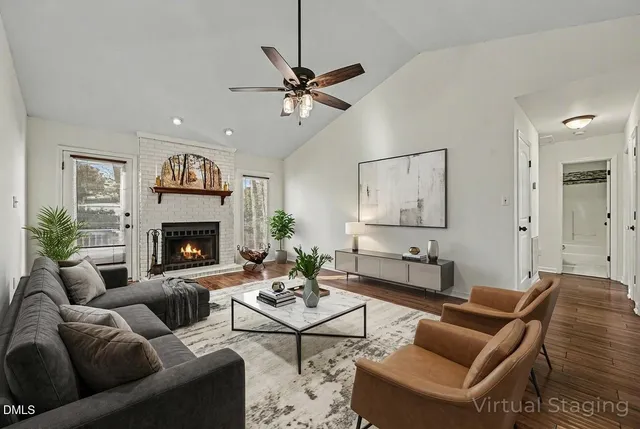a living room with furniture a table and a fireplace