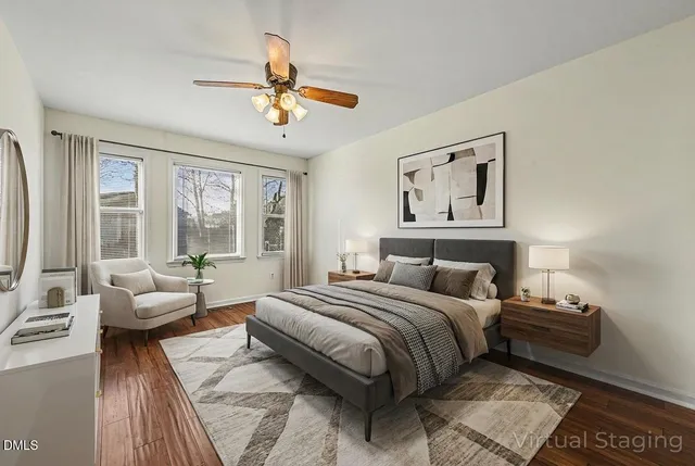 a bedroom with a large bed couch and a window