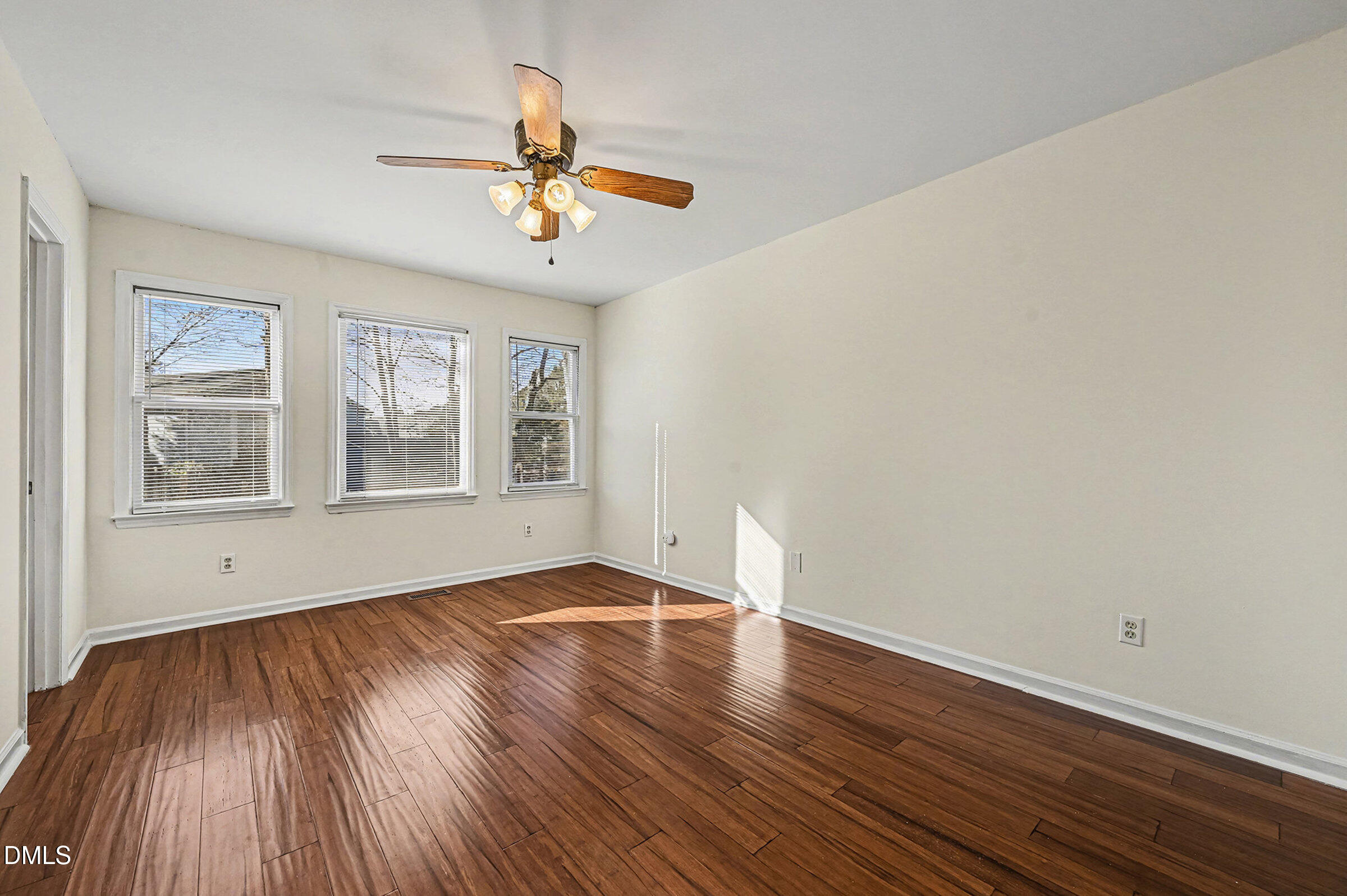 112 Rock Pointe Lane Cary, NC 27513 - Photo 14 of 35 a view of an empty room with wooden floor and a window