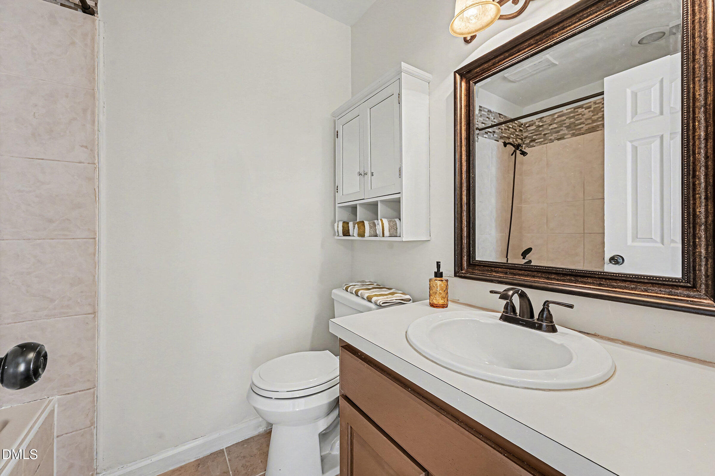 112 Rock Pointe Lane Cary, NC 27513 - Photo 18 of 35 a bathroom with a granite countertop sink and a mirror