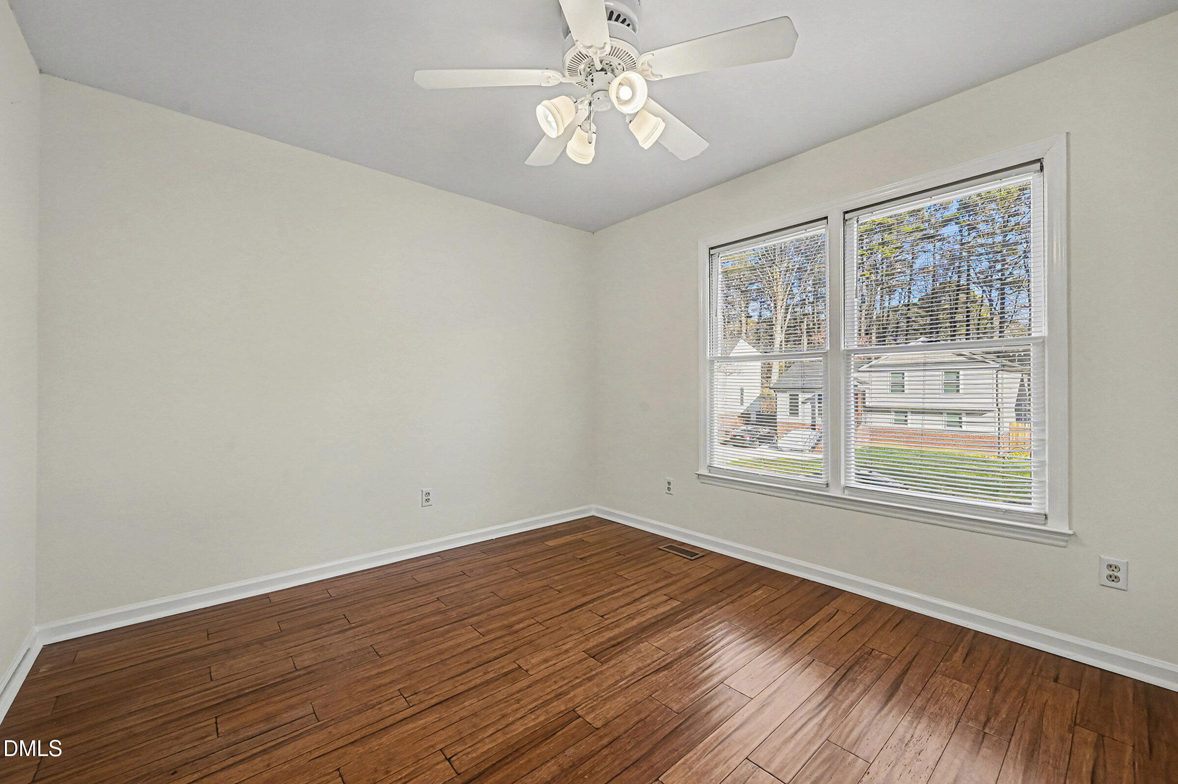 112 Rock Pointe Lane Cary, NC 27513 - Photo 20 of 35 a view of an empty room with wooden floor and a window