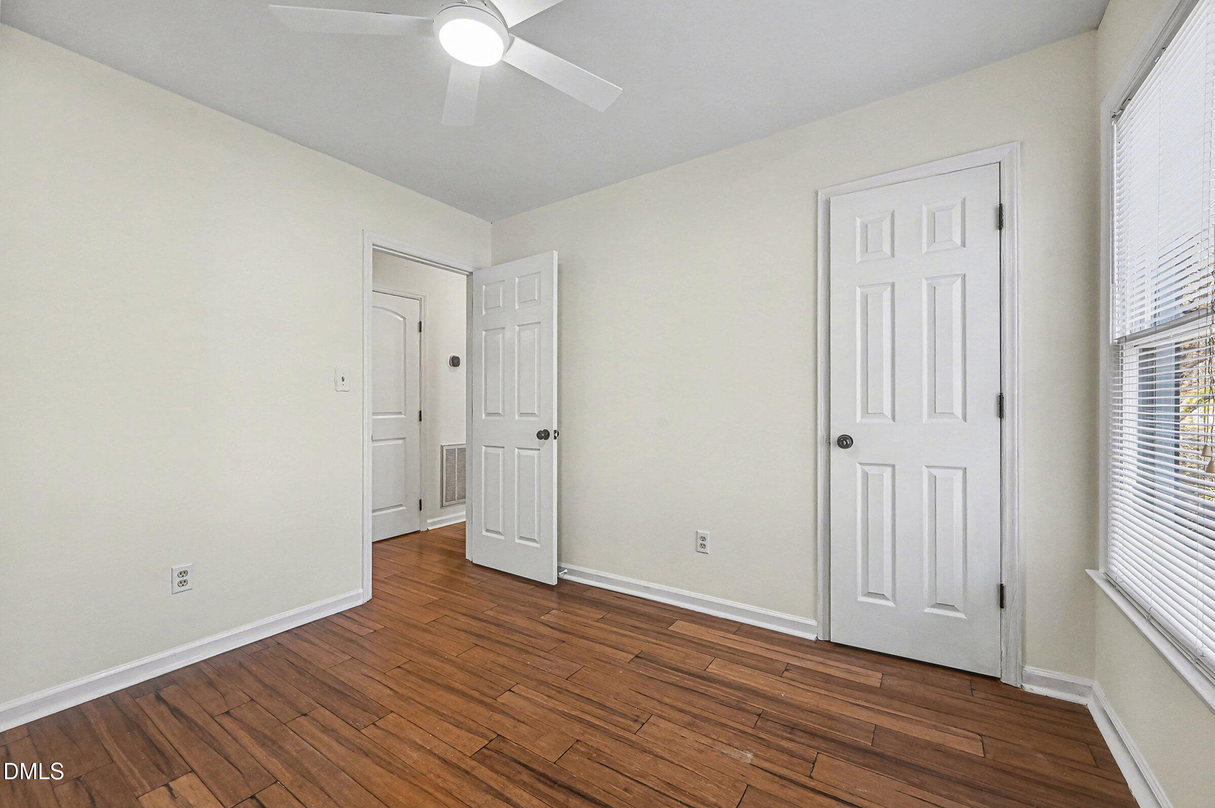 112 Rock Pointe Lane Cary, NC 27513 - Photo 21 of 35 an empty room with wooden floor and windows
