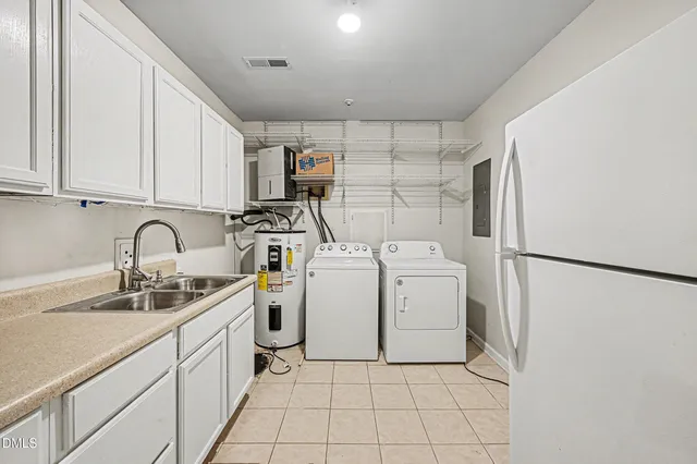 a view of a kitchen with sink washer and dryer