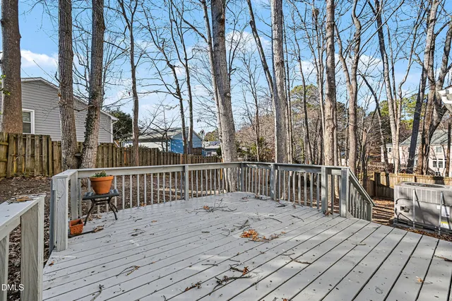 a view of balcony with wooden floor and fence