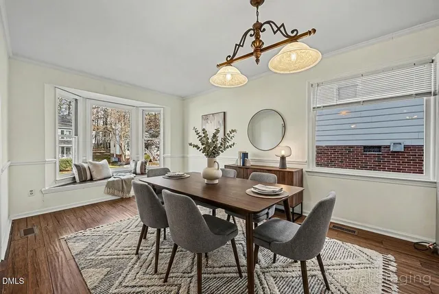 a view of a dining room with furniture and a large window