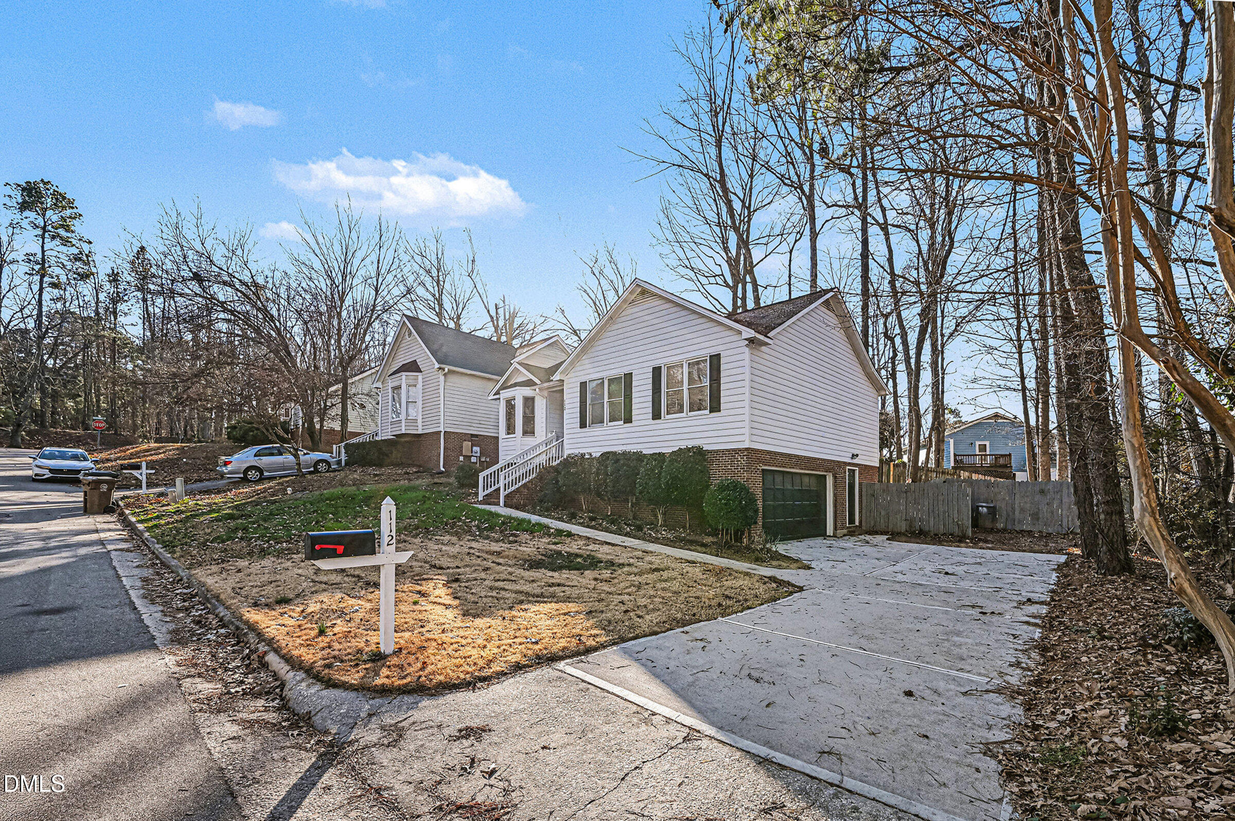 112 Rock Pointe Lane Cary, NC 27513 - Photo 31 of 35 a view of a white house next to a yard with big trees