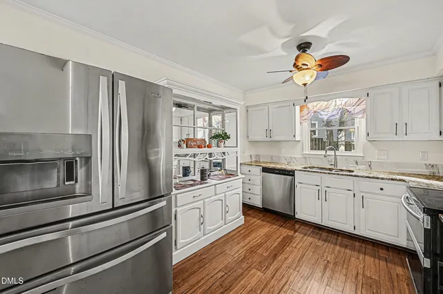 a kitchen with a white cabinets and window
