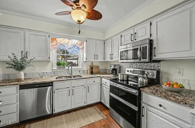 a kitchen with stainless steel appliances granite countertop a sink and cabinets