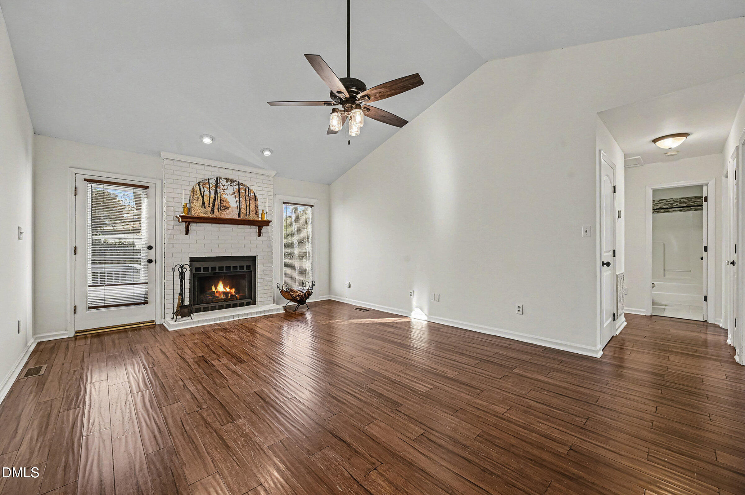 112 Rock Pointe Lane Cary, NC 27513 - Photo 8 of 35 a view of an empty room with wooden floor fireplace and a window