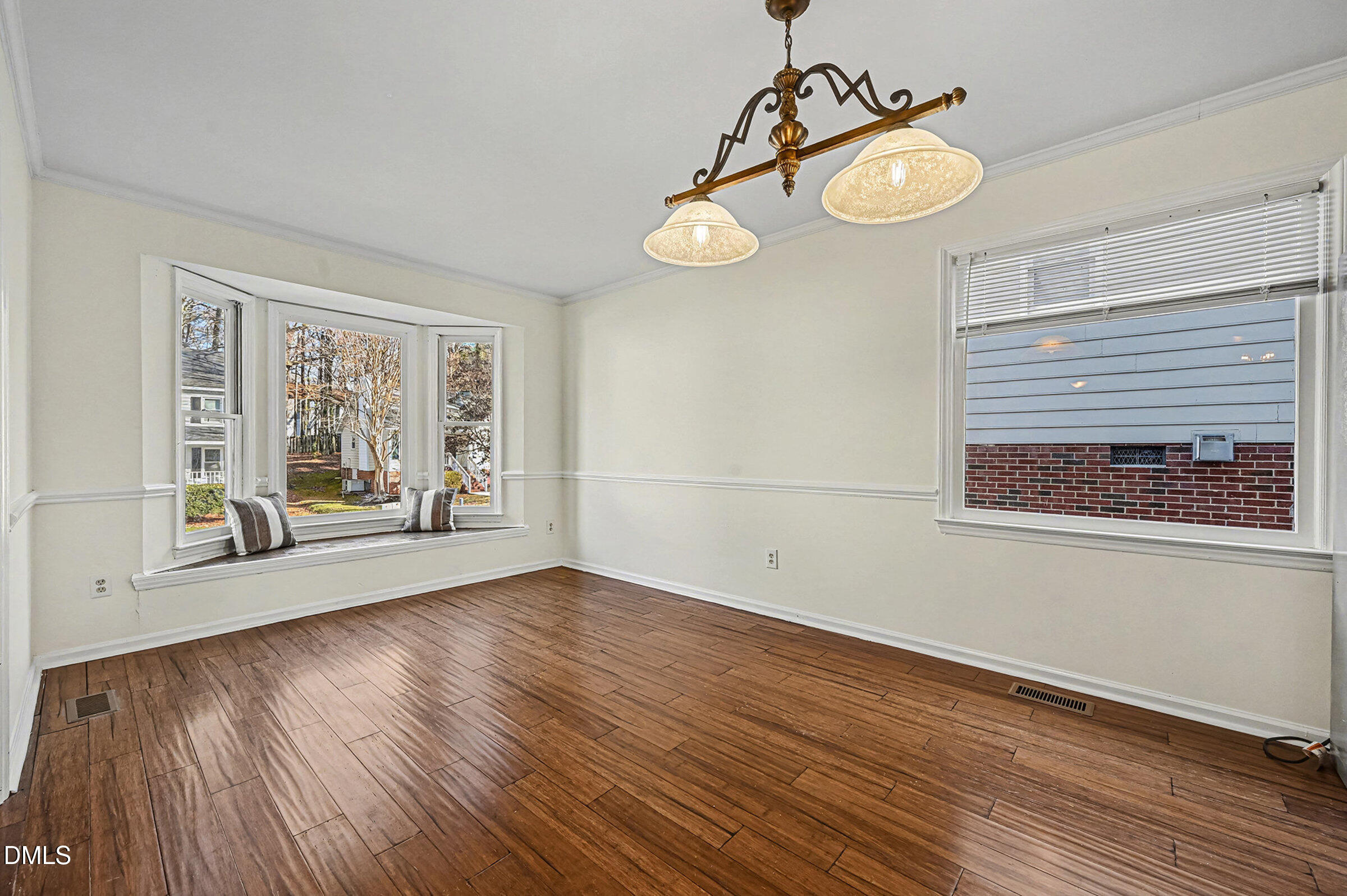 112 Rock Pointe Lane Cary, NC 27513 - Photo 9 of 35 a view of an empty room with wooden floor and a window