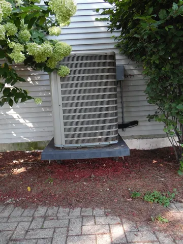 an empty room with a window and chandelier fan