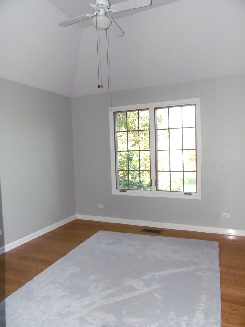 19057 South Saddlebrook Drive Shorewood, IL 60404 - Photo 29 of 56 an empty room with a window and chandelier fan