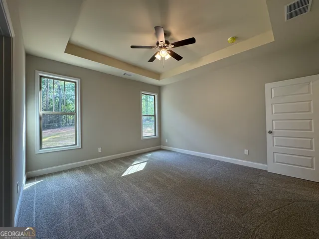 a view of a livingroom with a ceiling fan and window