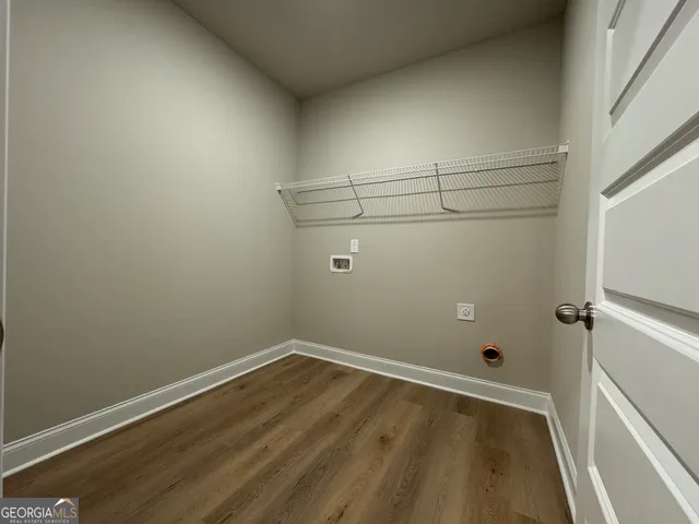 a view of a room with wooden floor