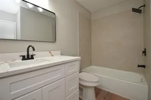 a bathroom with a sink a toilet and bathtub