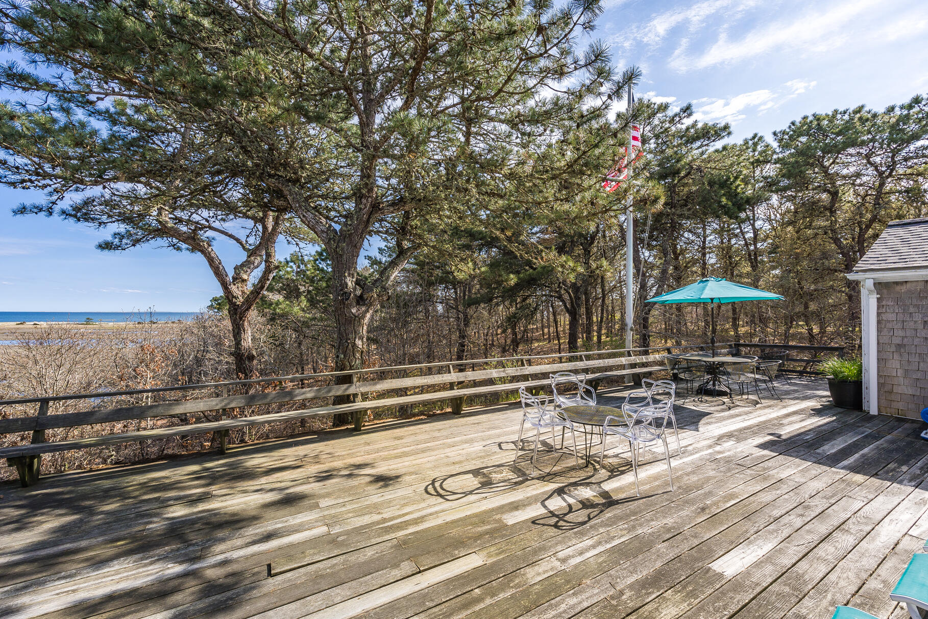 189 Bay View Road Chatham, MA 02659 - Photo 14 of 59 a view of a terrace with wooden floor and outdoor seating