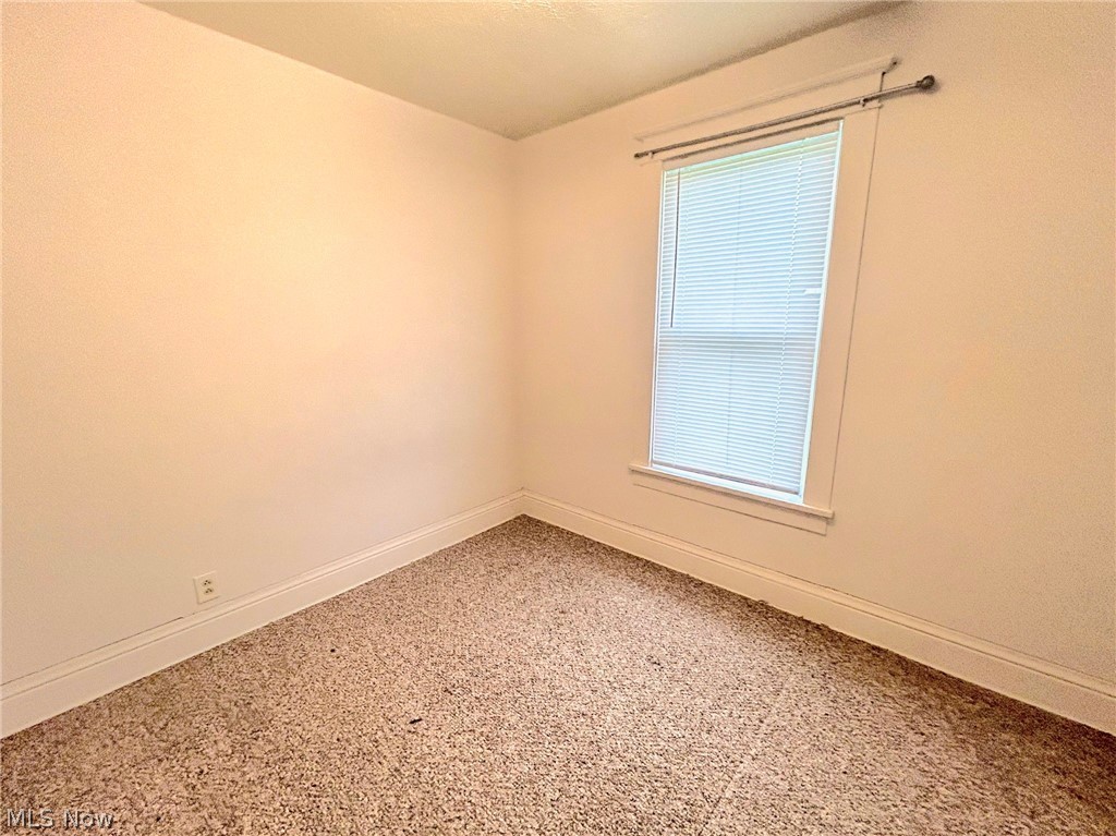 4722 Warren - Sharon Road Vienna, OH 44473 - Photo 5 of 8 Empty room with a healthy amount of sunlight and light carpet