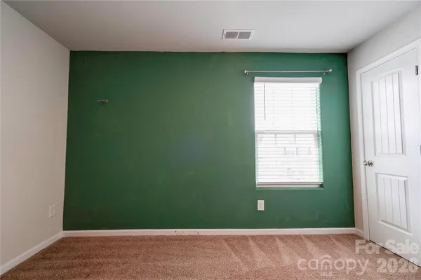 a view of a room that has a window and a plant