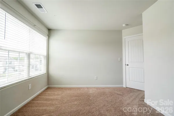 a view of an empty room and a window