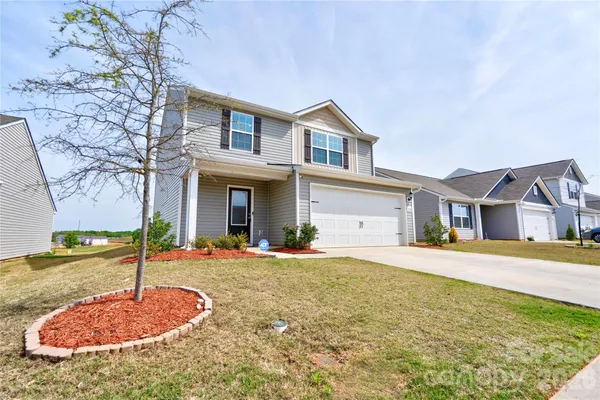 a front view of a house with a yard