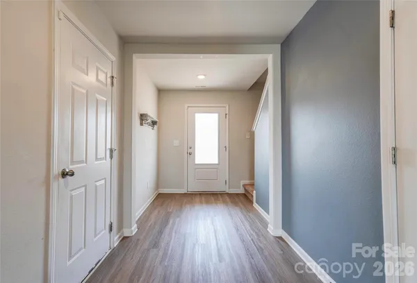 a view of a hallway with wooden floor