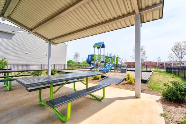 a view of swimming pool with outdoor seating and plants
