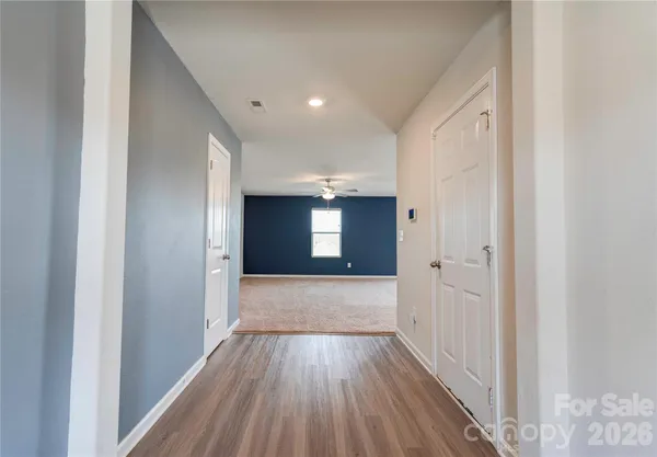 a view of hallway with wooden floor