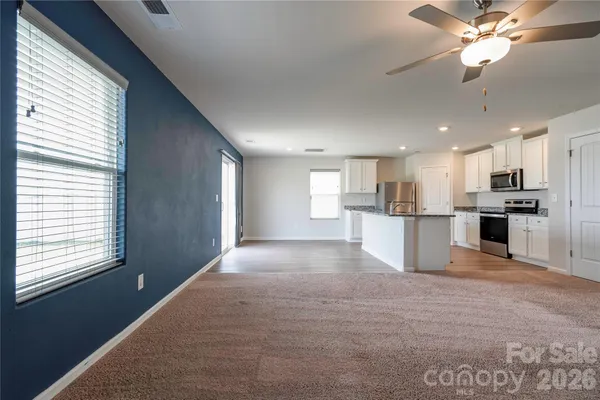 a view of kitchen with refrigerator and window