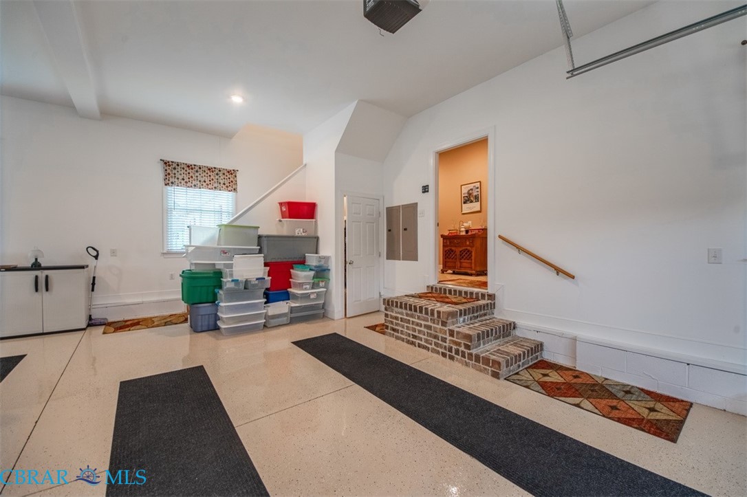 120 North Shore Road Locust Hill, VA 23092 - Photo 11 of 39 Interior of attached garage with walk-up steps to attic storage space.