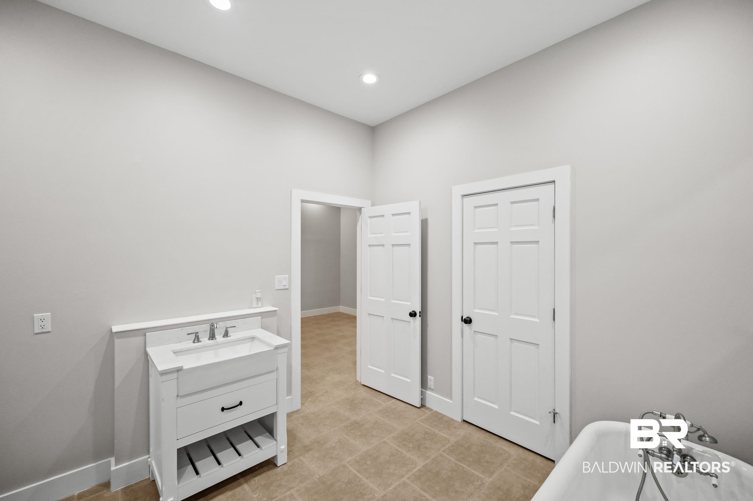 15031 Timber Ridge Drive Loxley, AL 36551 - Photo 23 of 43 Bathroom with tile patterned floors, a tub to relax in, and vanity