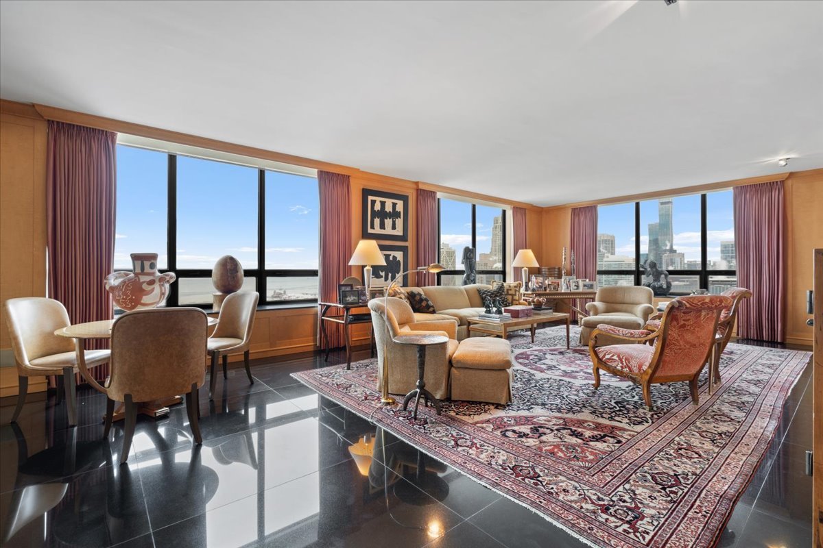 180 East Pearson Street, Unit 3304 Chicago, IL 60611 - Photo 4 of 17 a living room with furniture large windows and wooden floor
