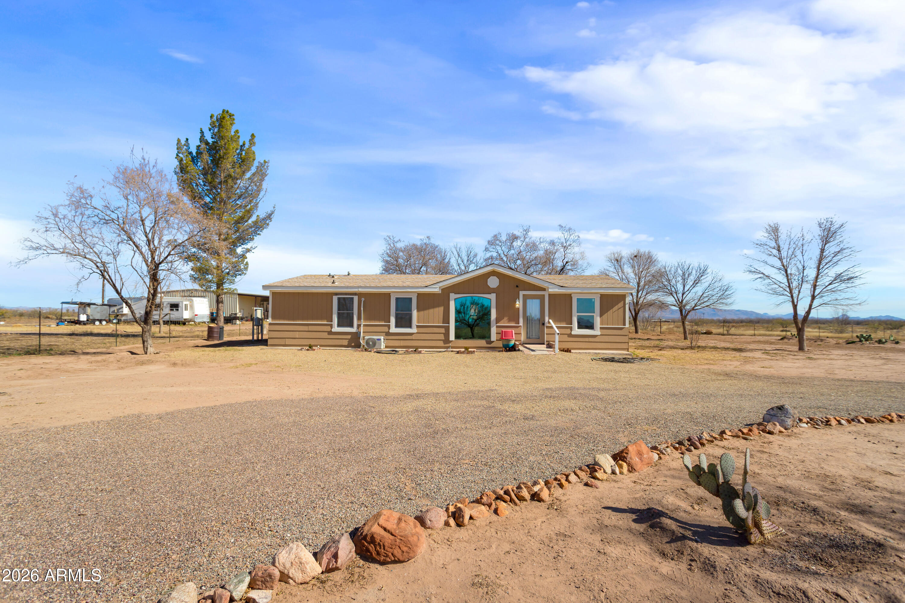 10405 North Mormon Road Elfrida, AZ 85610 - Photo 2 of 43 a front view of a house with a yard
