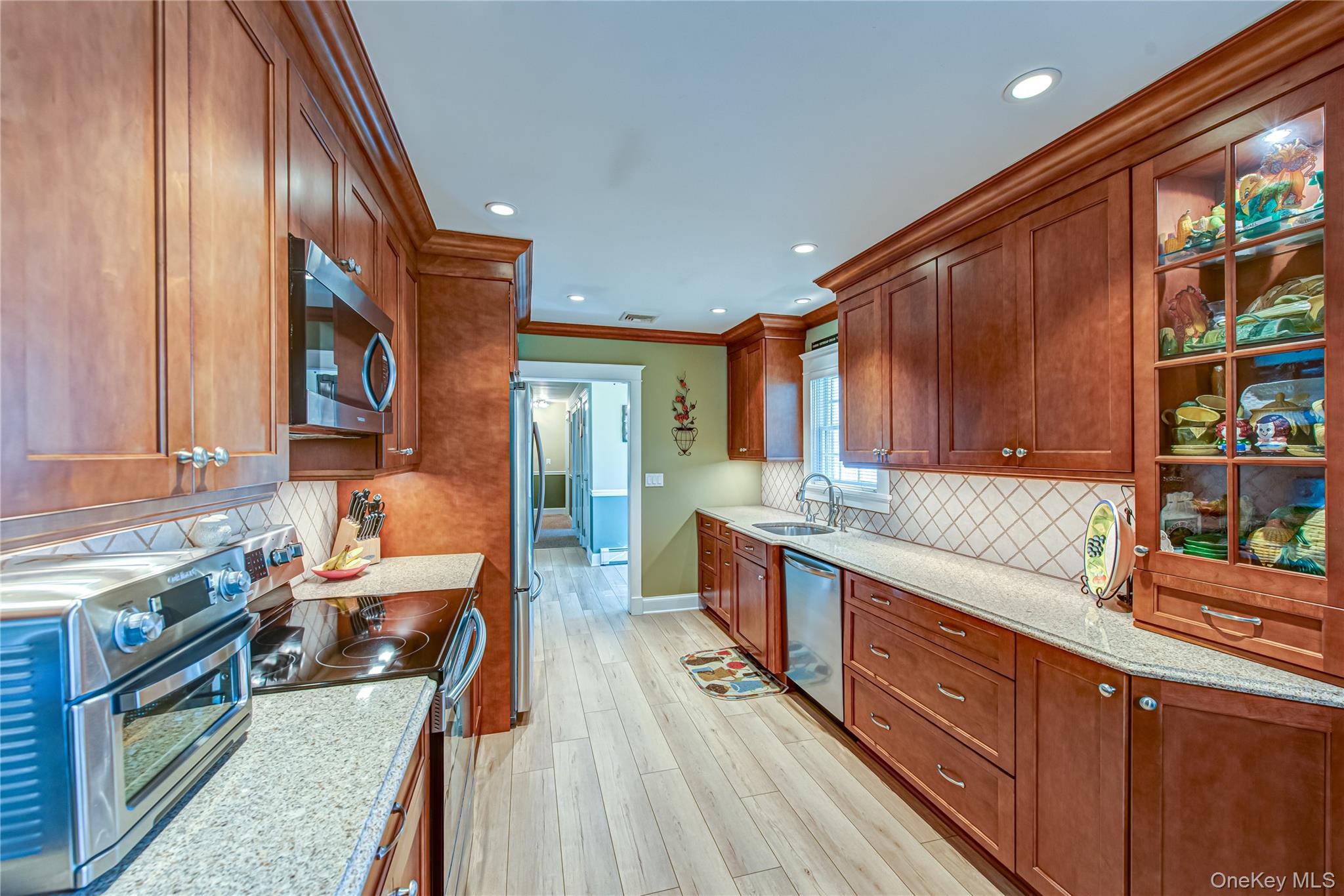 3 Walnut Road Rocky Point, NY 11778 - Photo 13 of 46 a kitchen with stainless steel appliances granite countertop a sink stove and cabinets