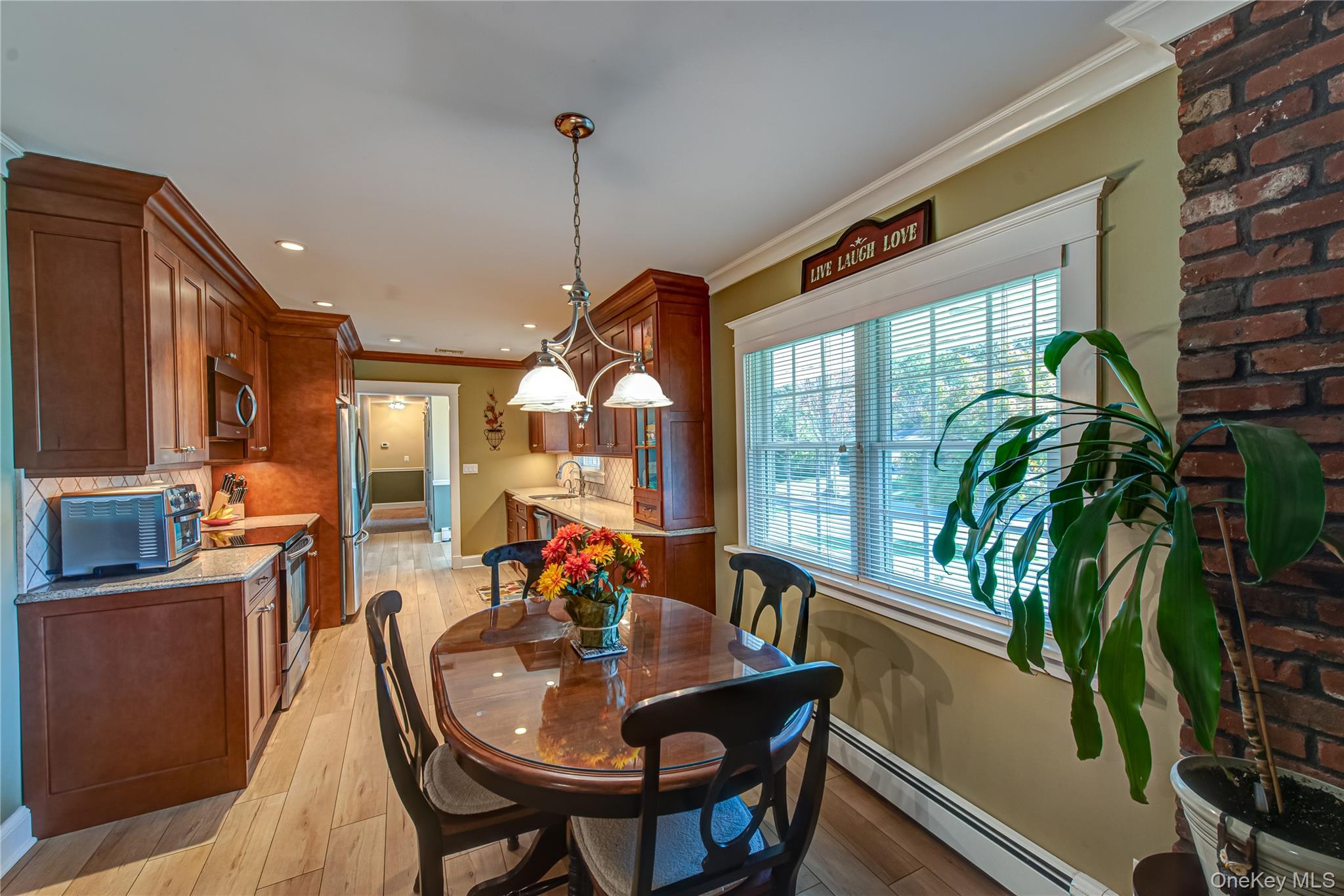 3 Walnut Road Rocky Point, NY 11778 - Photo 14 of 46 a view of a dining room and livingroom with furniture wooden floor a chandelier