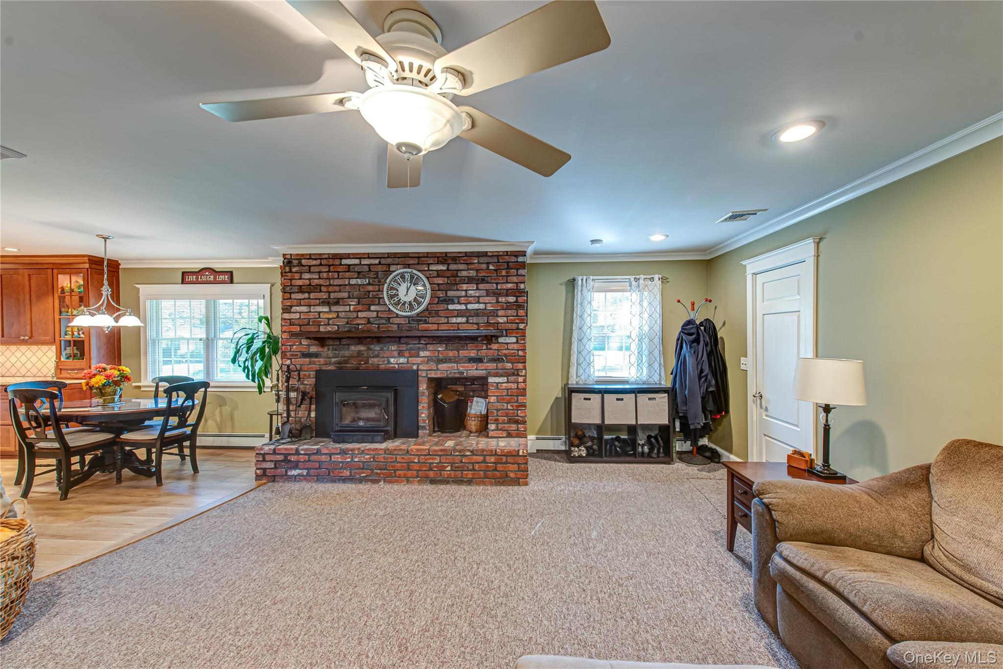 3 Walnut Road Rocky Point, NY 11778 - Photo 22 of 46 a living room with furniture a fireplace and a chandelier